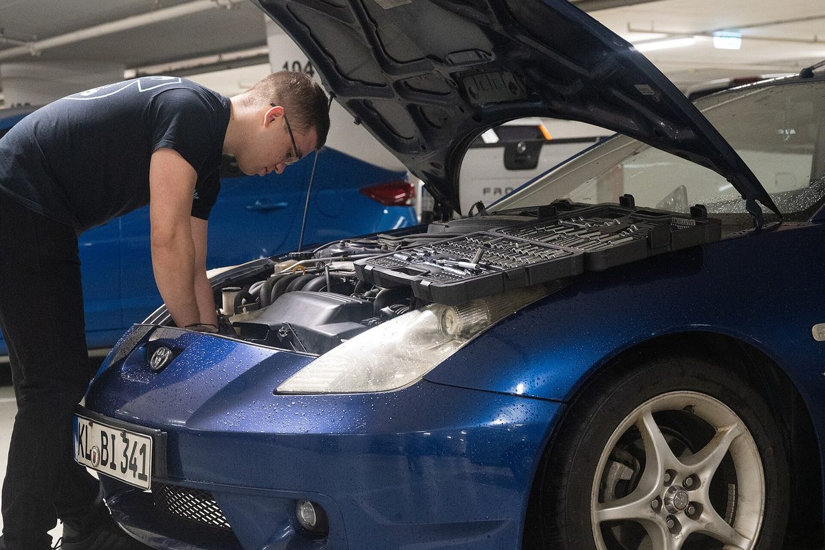 A mechanic inspecting an engine